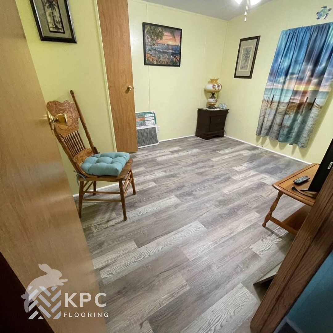 Gray wood-look plank floor installed in a small room