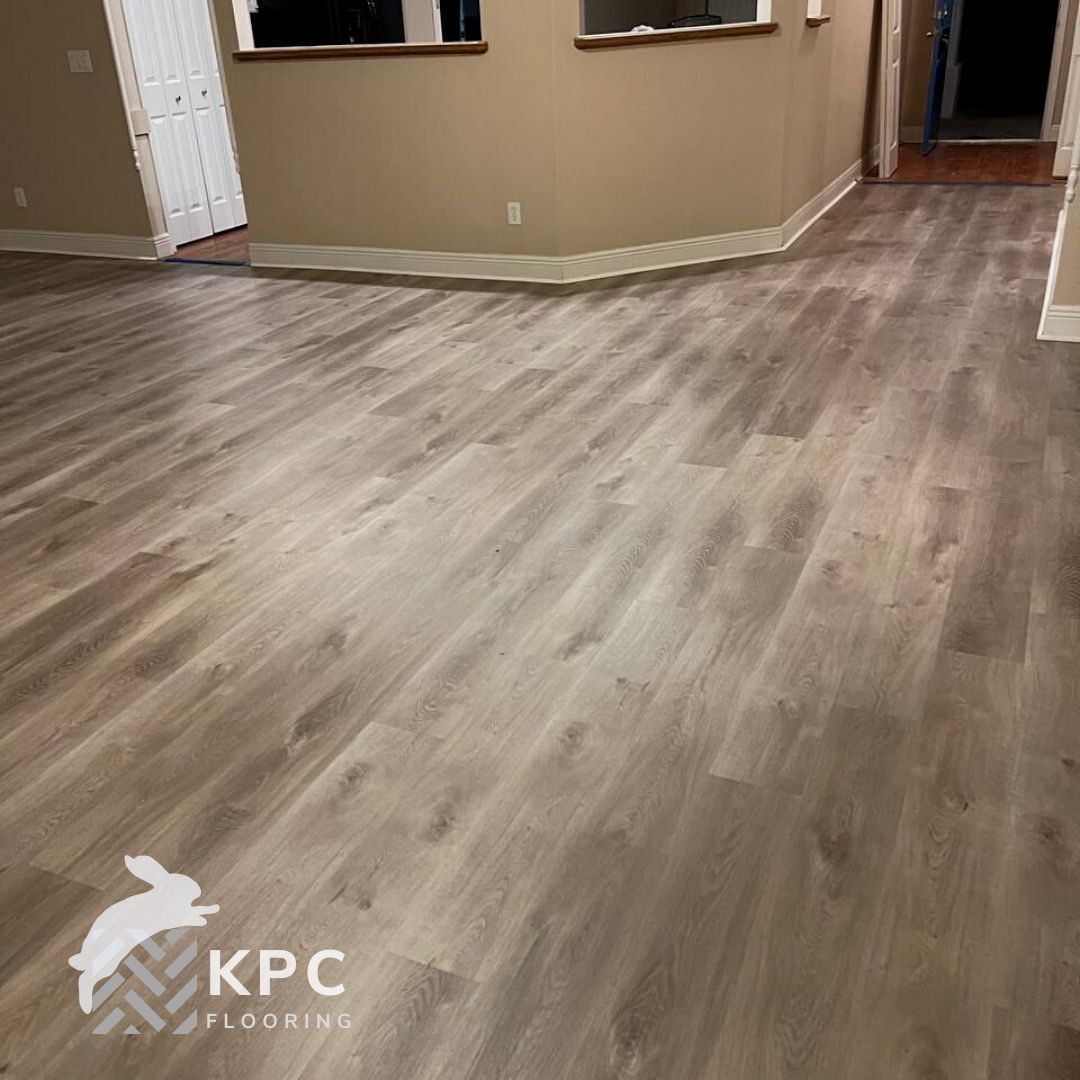 Gray-brown oak-look vinyl plank floor across an open living area